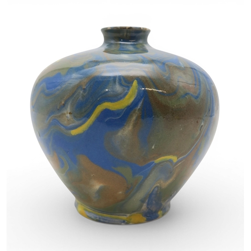 53A - A marbled slipware vase of squat baluster form with small flared lip, in hues of blue and brown over...