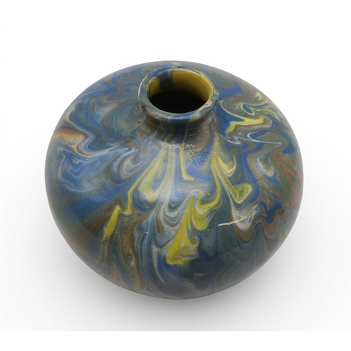 53A - A marbled slipware vase of squat baluster form with small flared lip, in hues of blue and brown over...