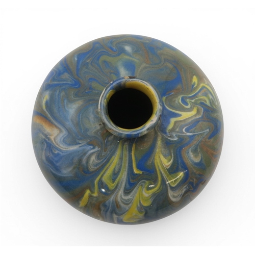 53A - A marbled slipware vase of squat baluster form with small flared lip, in hues of blue and brown over...