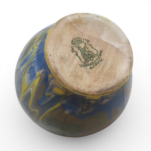 53A - A marbled slipware vase of squat baluster form with small flared lip, in hues of blue and brown over...
