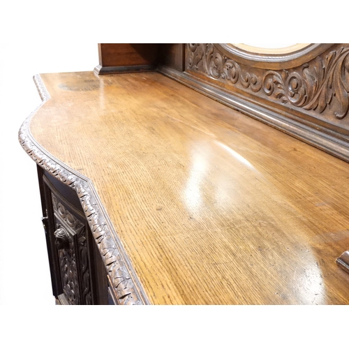 2028 - A LARGE LATE 19TH CENTURY CONTINENTAL OAK MIRROR BACK SIDEBOARDwith moulded projecting cornice on ca... 