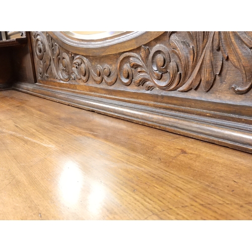 2028 - A LARGE LATE 19TH CENTURY CONTINENTAL OAK MIRROR BACK SIDEBOARDwith moulded projecting cornice on ca... 