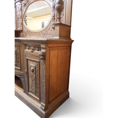 2028 - A LARGE LATE 19TH CENTURY CONTINENTAL OAK MIRROR BACK SIDEBOARDwith moulded projecting cornice on ca... 