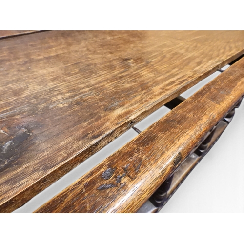 2034 - A 17TH/18TH CENTURY OAK SIX PANEL BACKED SETTLEpanelled back carved with king and men at arms surmou... 