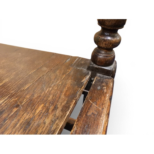 2034 - A 17TH/18TH CENTURY OAK SIX PANEL BACKED SETTLEpanelled back carved with king and men at arms surmou... 