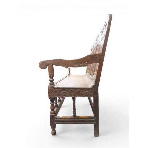 2034 - A 17TH/18TH CENTURY OAK SIX PANEL BACKED SETTLEpanelled back carved with king and men at arms surmou... 