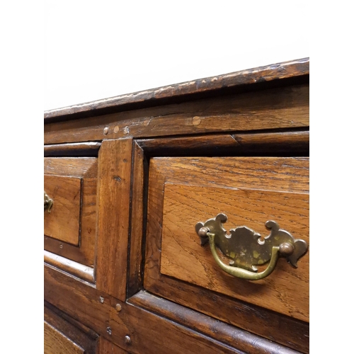 2035 - AN 18TH CENTURY OAK KITCHEN DRESSER BASEwith three plank top over three short drawers and panel cabi... 