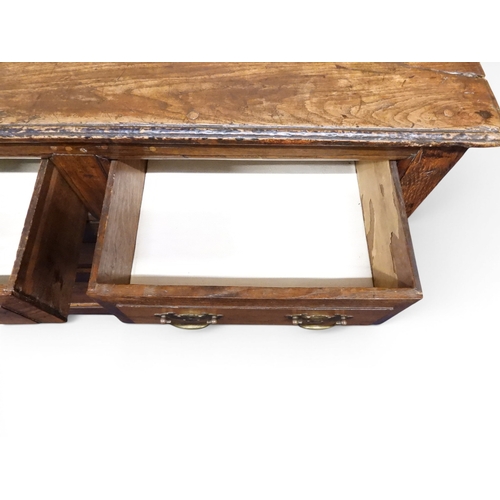 2035 - AN 18TH CENTURY OAK KITCHEN DRESSER BASEwith three plank top over three short drawers and panel cabi... 