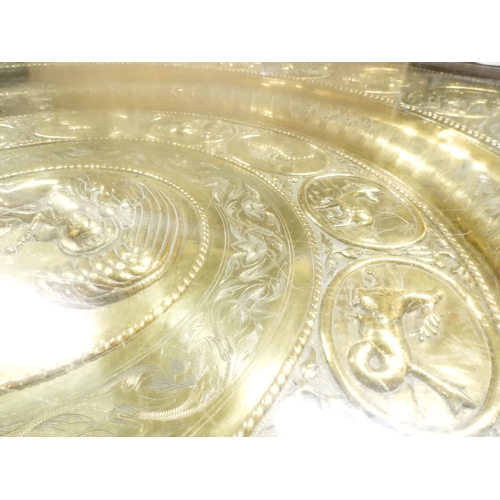2053 - A LARGE ARABESQUE STYLE OCTAGONAL CENTRE TABLEwith central circular brass tray embossed with reclini... 