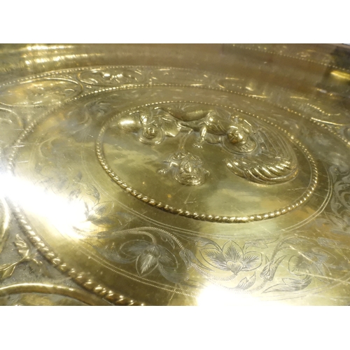 2053 - A LARGE ARABESQUE STYLE OCTAGONAL CENTRE TABLEwith central circular brass tray embossed with reclini... 