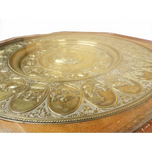 2053 - A LARGE ARABESQUE STYLE OCTAGONAL CENTRE TABLEwith central circular brass tray embossed with reclini... 