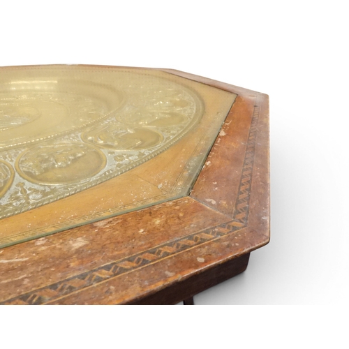 2053 - A LARGE ARABESQUE STYLE OCTAGONAL CENTRE TABLEwith central circular brass tray embossed with reclini... 