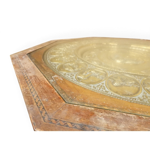 2053 - A LARGE ARABESQUE STYLE OCTAGONAL CENTRE TABLEwith central circular brass tray embossed with reclini... 