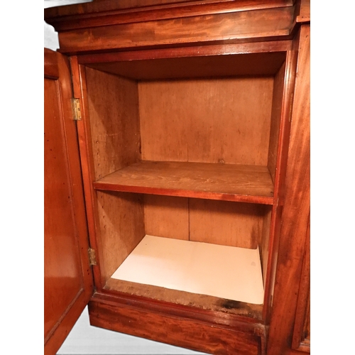 2055 - A LARGE VICTORIAN MAHOGANY BREAKFRONT LIBRARY BOOKCASEwith moulded cornice over four glazed doors on... 