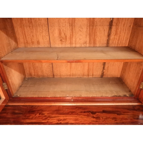 2055 - A LARGE VICTORIAN MAHOGANY BREAKFRONT LIBRARY BOOKCASEwith moulded cornice over four glazed doors on... 
