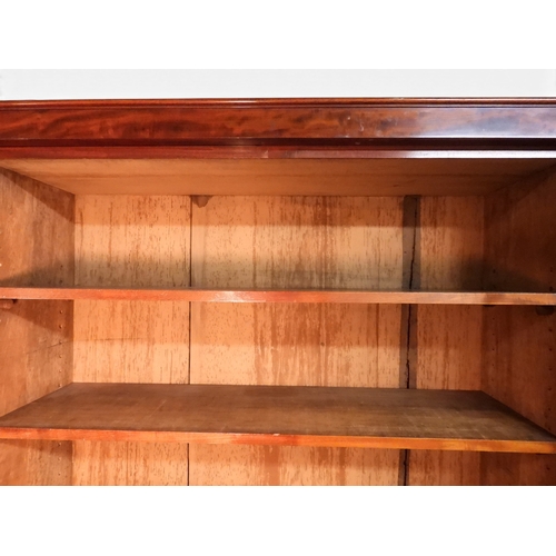 2055 - A LARGE VICTORIAN MAHOGANY BREAKFRONT LIBRARY BOOKCASEwith moulded cornice over four glazed doors on... 
