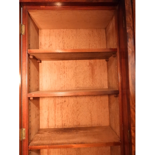 2055 - A LARGE VICTORIAN MAHOGANY BREAKFRONT LIBRARY BOOKCASEwith moulded cornice over four glazed doors on... 