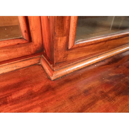2055 - A LARGE VICTORIAN MAHOGANY BREAKFRONT LIBRARY BOOKCASEwith moulded cornice over four glazed doors on... 