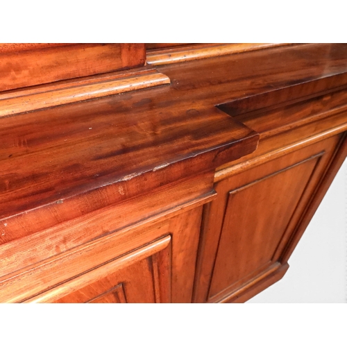 2055 - A LARGE VICTORIAN MAHOGANY BREAKFRONT LIBRARY BOOKCASEwith moulded cornice over four glazed doors on... 