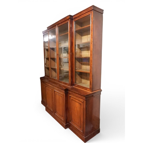 2055 - A LARGE VICTORIAN MAHOGANY BREAKFRONT LIBRARY BOOKCASEwith moulded cornice over four glazed doors on... 