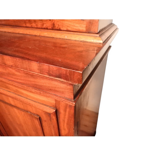 2055 - A LARGE VICTORIAN MAHOGANY BREAKFRONT LIBRARY BOOKCASEwith moulded cornice over four glazed doors on... 