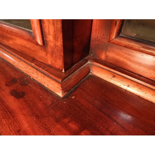 2055 - A LARGE VICTORIAN MAHOGANY BREAKFRONT LIBRARY BOOKCASEwith moulded cornice over four glazed doors on... 