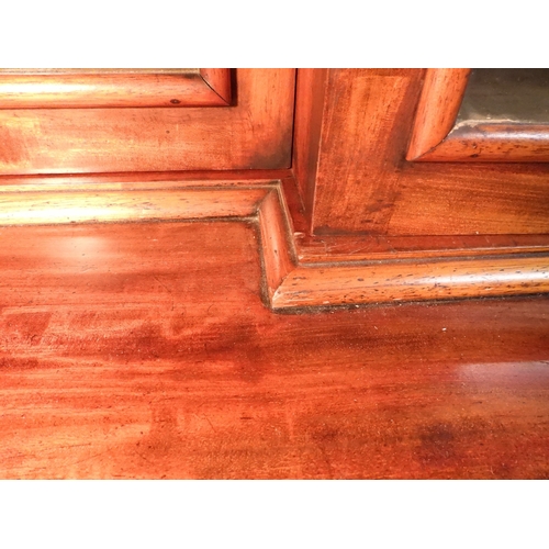 2055 - A LARGE VICTORIAN MAHOGANY BREAKFRONT LIBRARY BOOKCASEwith moulded cornice over four glazed doors on... 