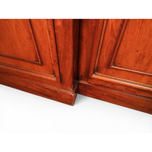 2055 - A LARGE VICTORIAN MAHOGANY BREAKFRONT LIBRARY BOOKCASEwith moulded cornice over four glazed doors on... 