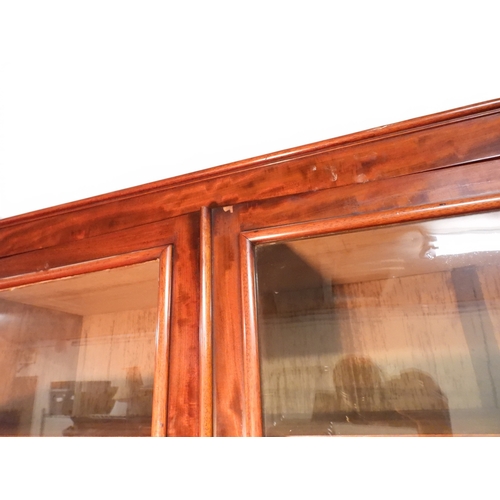 2055 - A LARGE VICTORIAN MAHOGANY BREAKFRONT LIBRARY BOOKCASEwith moulded cornice over four glazed doors on... 