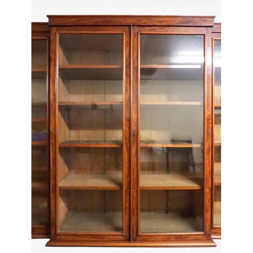 2055 - A LARGE VICTORIAN MAHOGANY BREAKFRONT LIBRARY BOOKCASEwith moulded cornice over four glazed doors on... 