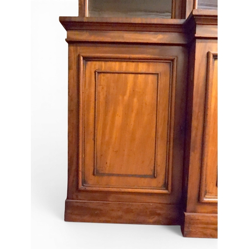 2055 - A LARGE VICTORIAN MAHOGANY BREAKFRONT LIBRARY BOOKCASEwith moulded cornice over four glazed doors on... 