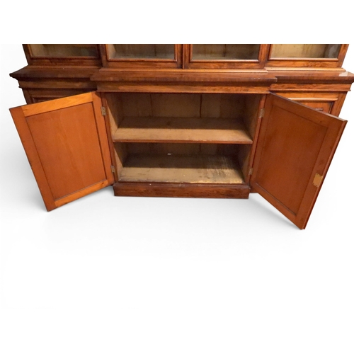 2055 - A LARGE VICTORIAN MAHOGANY BREAKFRONT LIBRARY BOOKCASEwith moulded cornice over four glazed doors on... 