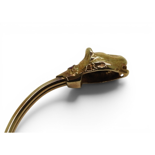 2756 - A LEOPARD BANGLEmade in 9ct gold and set with ruby eyes and collars. Inner diameter 6.2cm, weight 11... 