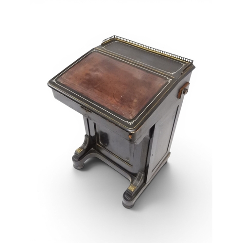 2002 - A VICTORIAN EBONISED AESTHETIC MOVEMENT DAVENPORT WRITING DESK with pierced brass gallery top over h... 