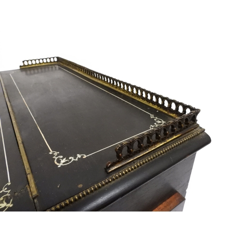 2002 - A VICTORIAN EBONISED AESTHETIC MOVEMENT DAVENPORT WRITING DESK with pierced brass gallery top over h... 