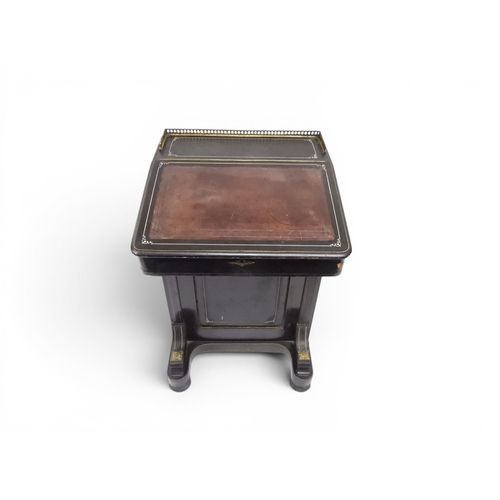 2002 - A VICTORIAN EBONISED AESTHETIC MOVEMENT DAVENPORT WRITING DESK with pierced brass gallery top over h... 