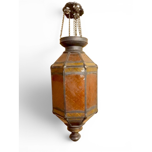 2004 - A LATE 19TH CENTURY MOROCCAN STYLE OCTAGONAL COPPER AND STAINED GLASS CANDLE LANTERNwith rise and fa... 