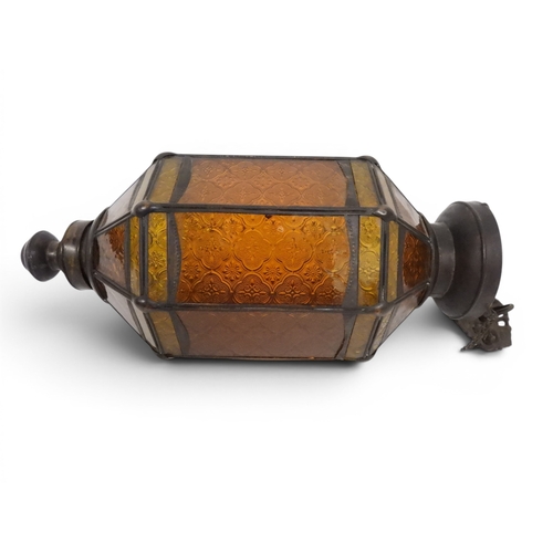2004 - A LATE 19TH CENTURY MOROCCAN STYLE OCTAGONAL COPPER AND STAINED GLASS CANDLE LANTERNwith rise and fa... 