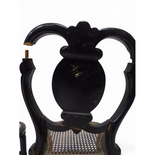 2009 - A 19TH CENTURY BLACK LACQUERED PAPIER MACHE BERGERE PARLOUR CHAIRwith moulded gilt painted mother of... 
