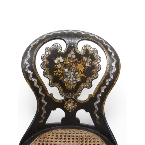 2009 - A 19TH CENTURY BLACK LACQUERED PAPIER MACHE BERGERE PARLOUR CHAIRwith moulded gilt painted mother of... 