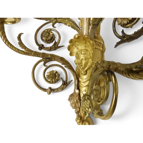 2014 - A PAIR OF 20TH CENTURY GILT METAL REGENCY STYLE FIVE BRANCH CANDLE WALL SCONCESwith scrolled floral ... 