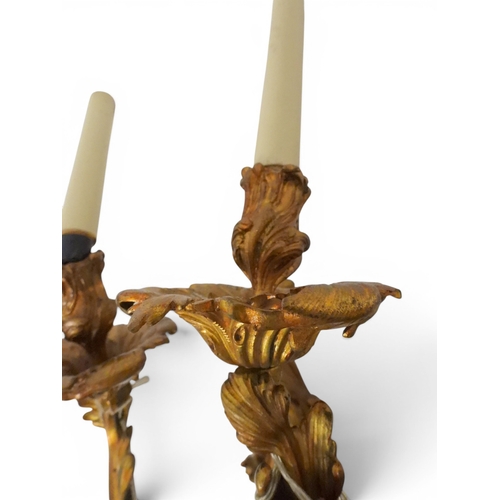 2014 - A PAIR OF 20TH CENTURY GILT METAL REGENCY STYLE FIVE BRANCH CANDLE WALL SCONCESwith scrolled floral ... 