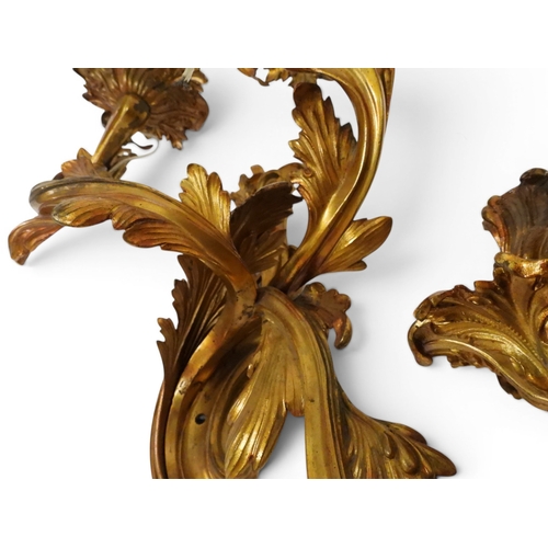 2014 - A PAIR OF 20TH CENTURY GILT METAL REGENCY STYLE FIVE BRANCH CANDLE WALL SCONCESwith scrolled floral ... 
