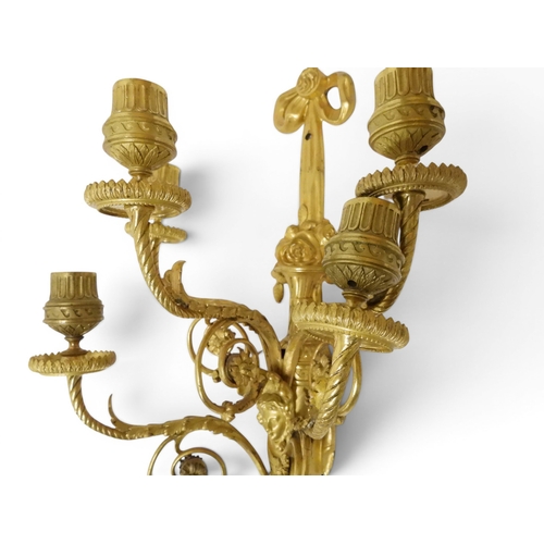 2014 - A PAIR OF 20TH CENTURY GILT METAL REGENCY STYLE FIVE BRANCH CANDLE WALL SCONCESwith scrolled floral ... 