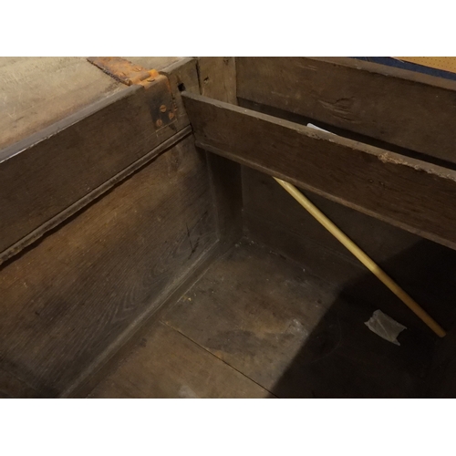 2022 - A 17TH/18TH CENTURY OAK BLANKET CHESTwith three panel lid with wrought iron fitting over carved thre... 
