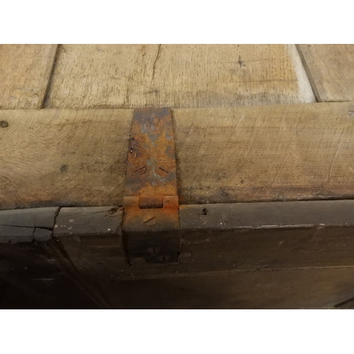 2022 - A 17TH/18TH CENTURY OAK BLANKET CHESTwith three panel lid with wrought iron fitting over carved thre... 