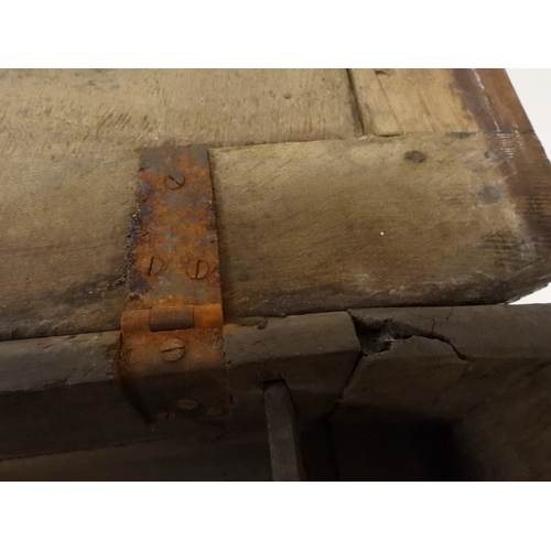 2022 - A 17TH/18TH CENTURY OAK BLANKET CHESTwith three panel lid with wrought iron fitting over carved thre... 
