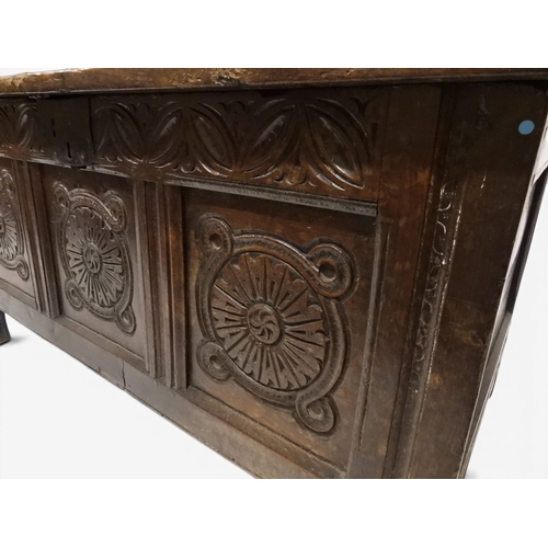 2022 - A 17TH/18TH CENTURY OAK BLANKET CHESTwith three panel lid with wrought iron fitting over carved thre... 