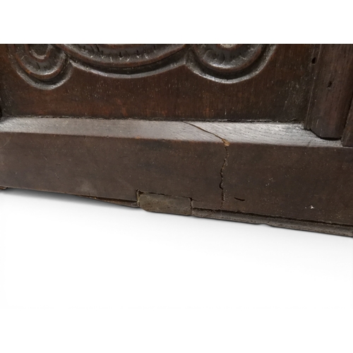 2022 - A 17TH/18TH CENTURY OAK BLANKET CHESTwith three panel lid with wrought iron fitting over carved thre... 
