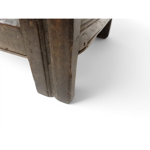 2022 - A 17TH/18TH CENTURY OAK BLANKET CHESTwith three panel lid with wrought iron fitting over carved thre... 